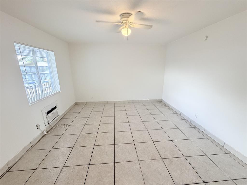 1829 North A Street, Unit 13 Lake Worth Beach, FL 33460 - Photo 4 of 14 a view of an empty room and window chandelier fan