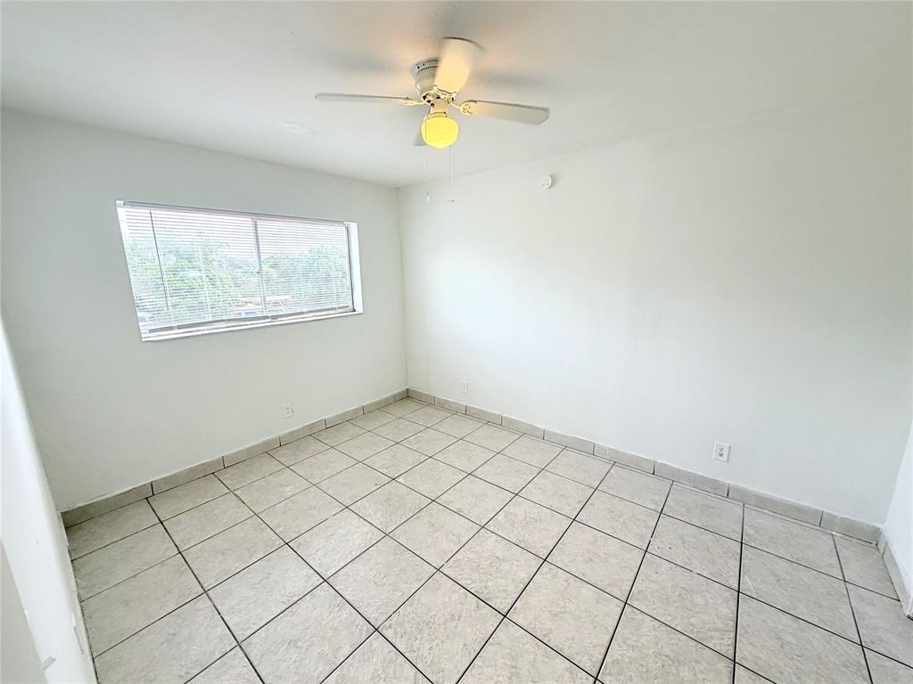 1829 North A Street, Unit 13 Lake Worth Beach, FL 33460 - Photo 5 of 14 a view of an empty room and window