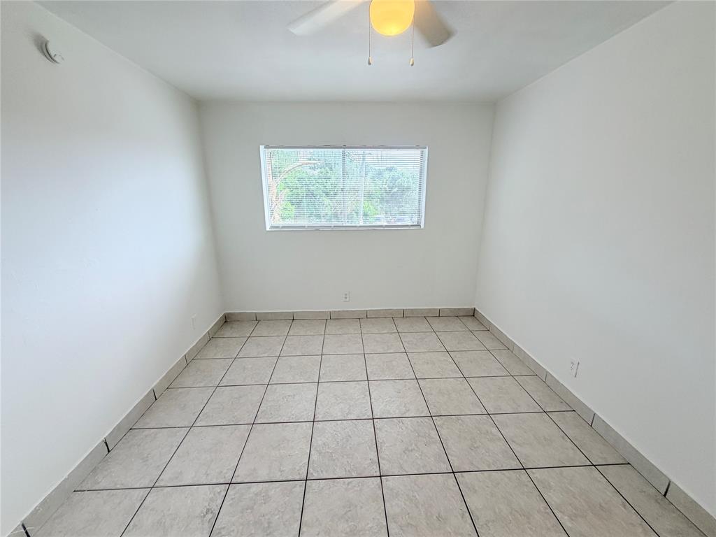 1829 North A Street, Unit 13 Lake Worth Beach, FL 33460 - Photo 9 of 14 a view of an empty room and window