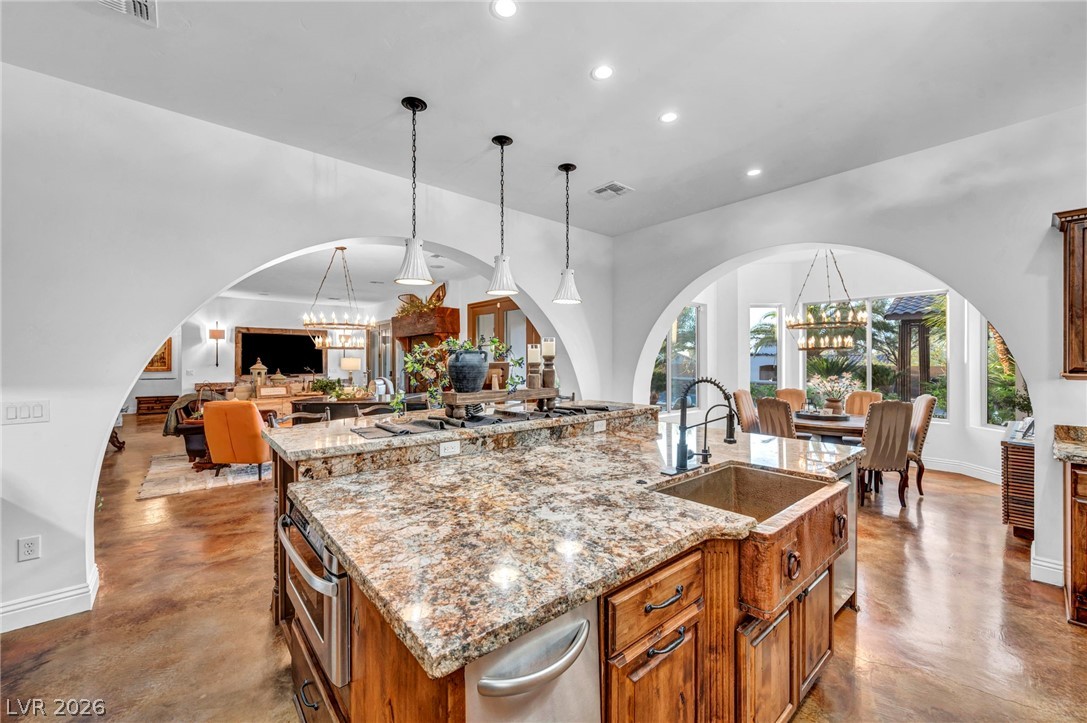 1158 Christian Road Henderson, NV 89002 - Photo 14 of 71 This spacious kitchen, featuring a central island, flows into open living and dining areas, perfect for entertaining.