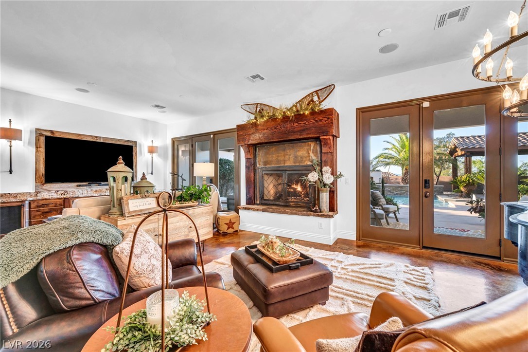 1158 Christian Road Henderson, NV 89002 - Photo 17 of 71 This inviting living space features a captivating fireplace and French doors leading to an outdoor oasis.