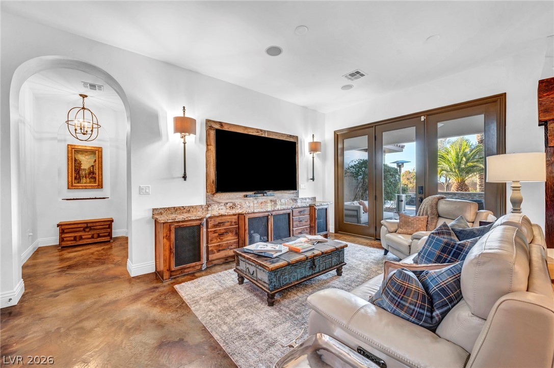 1158 Christian Road Henderson, NV 89002 - Photo 18 of 71 This inviting living room features elegant flooring, an arched entryway, and access to outdoor living.
