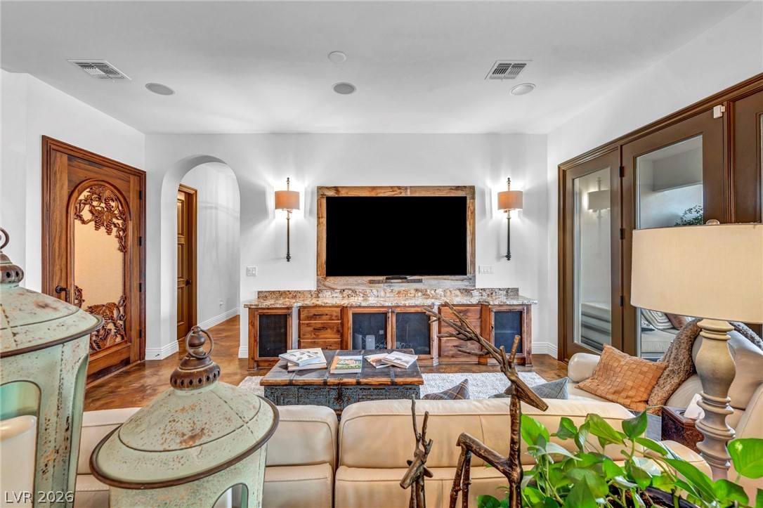 1158 Christian Road Henderson, NV 89002 - Photo 19 of 71 This inviting living room showcases a rich wood door and exquisite flooring.