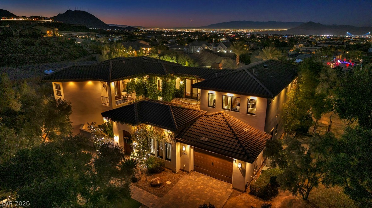 1158 Christian Road Henderson, NV 89002 - Photo 2 of 71 An inviting exterior, beautifully lit, with a spacious garage, and a scenic city view.
