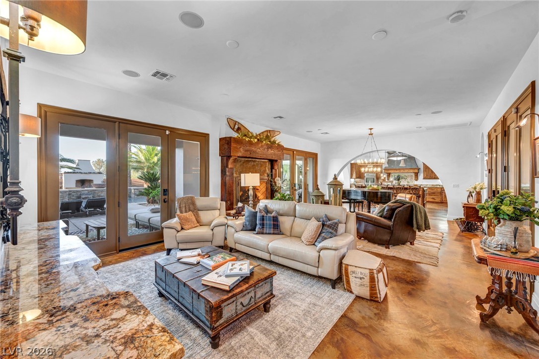 1158 Christian Road Henderson, NV 89002 - Photo 20 of 71 This living room features rich wood floors, a cozy fireplace, and direct patio access.