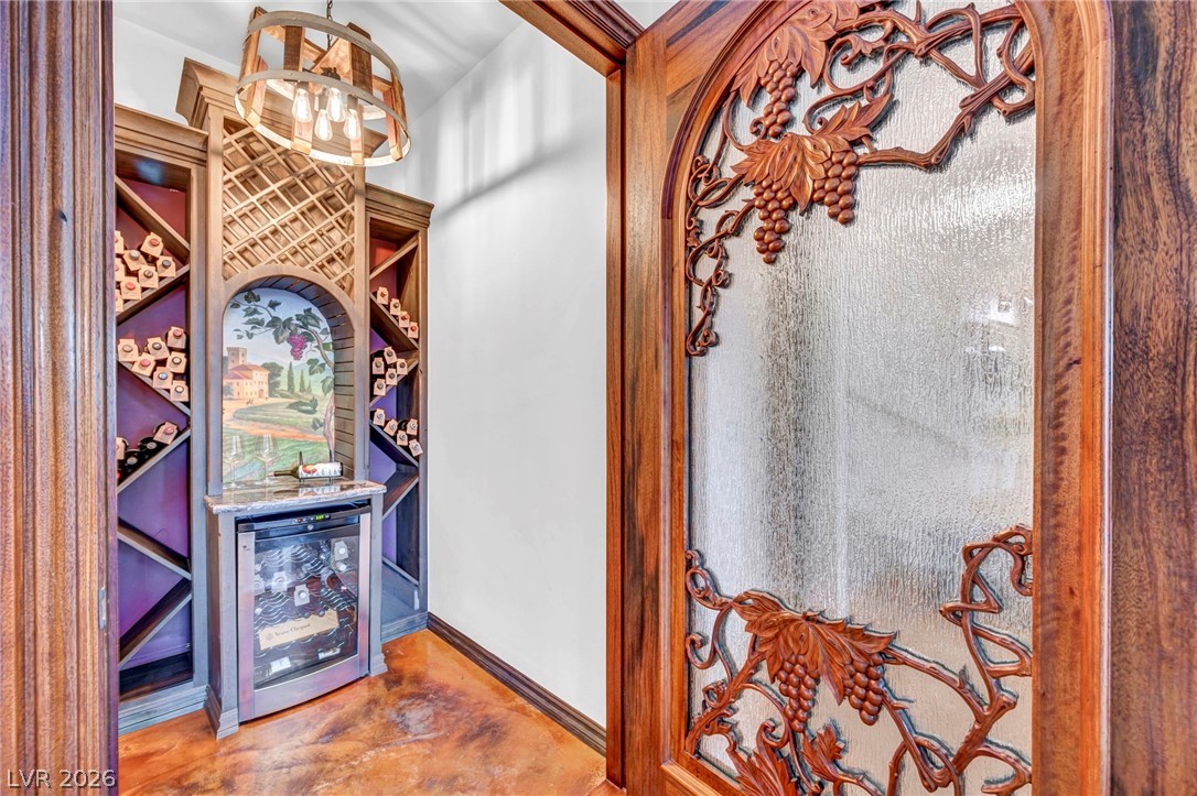 1158 Christian Road Henderson, NV 89002 - Photo 22 of 71 This wine cellar features intricate wooden details and a built-in wine cooler, perfect for entertaining.