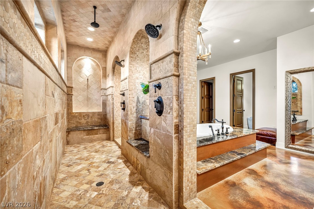 1158 Christian Road Henderson, NV 89002 - Photo 29 of 71 This luxurious primary bathroom offers an expansive walk-in shower and a freestanding soaking tub.
