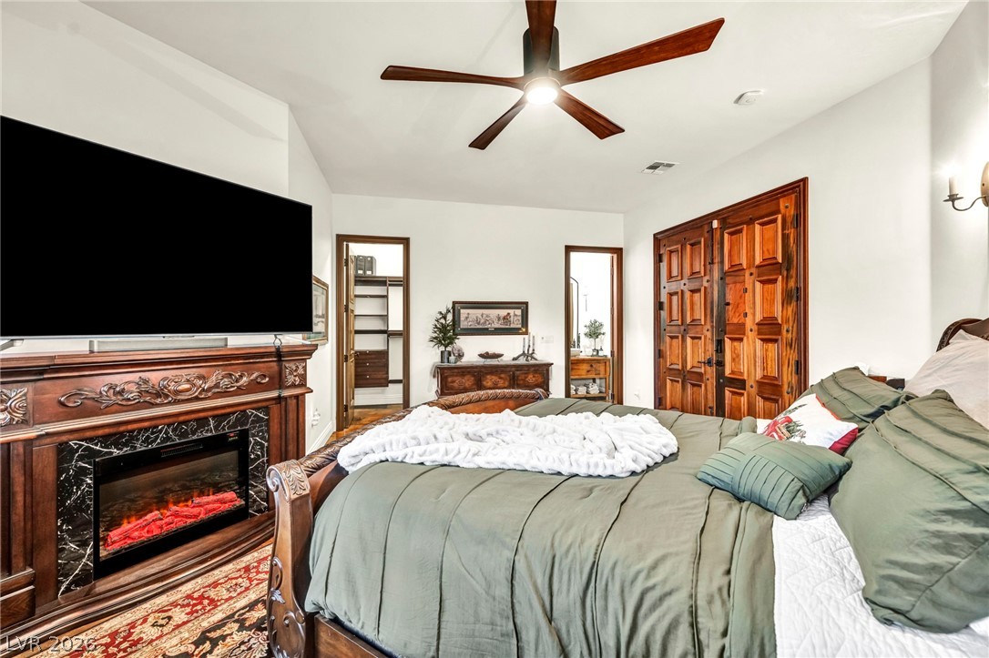 1158 Christian Road Henderson, NV 89002 - Photo 31 of 71 This spacious bedroom features a cozy fireplace and convenient walk-in closet access.