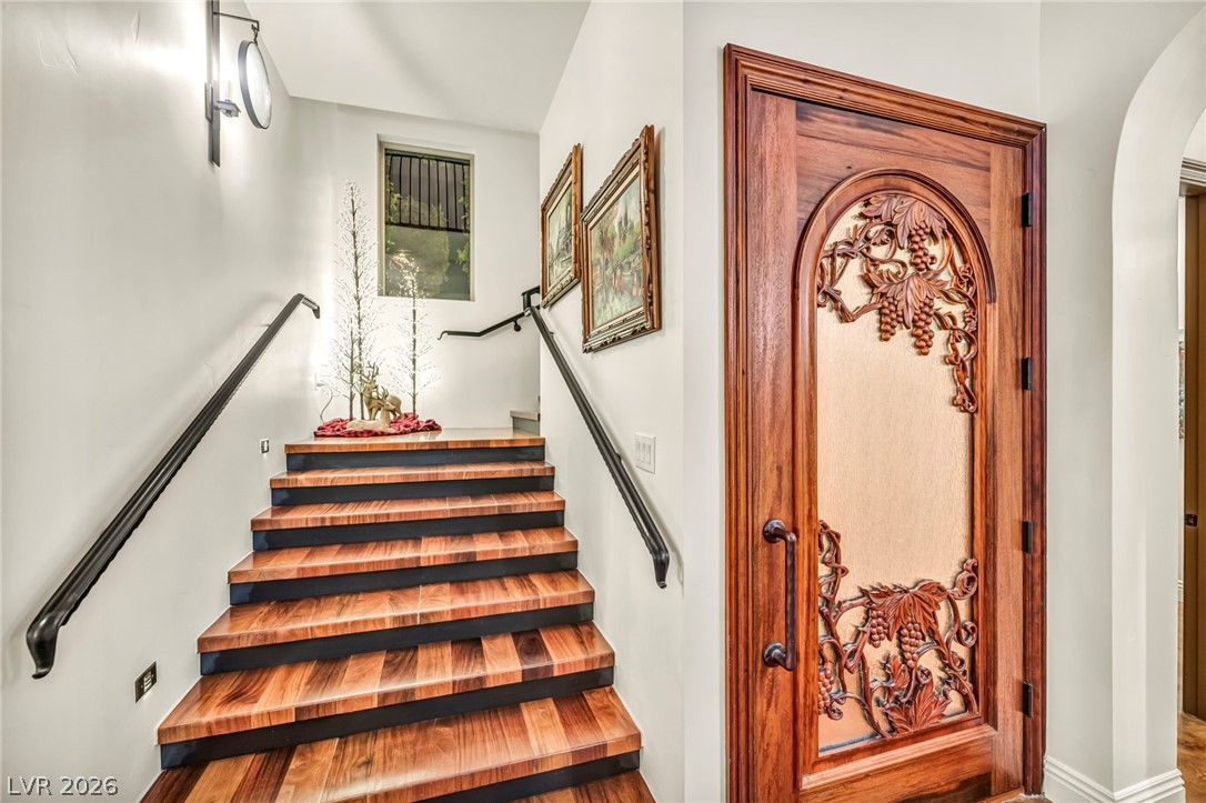 1158 Christian Road Henderson, NV 89002 - Photo 33 of 71 This exquisite entryway features a beautifully carved door and elegant wooden stairs.
