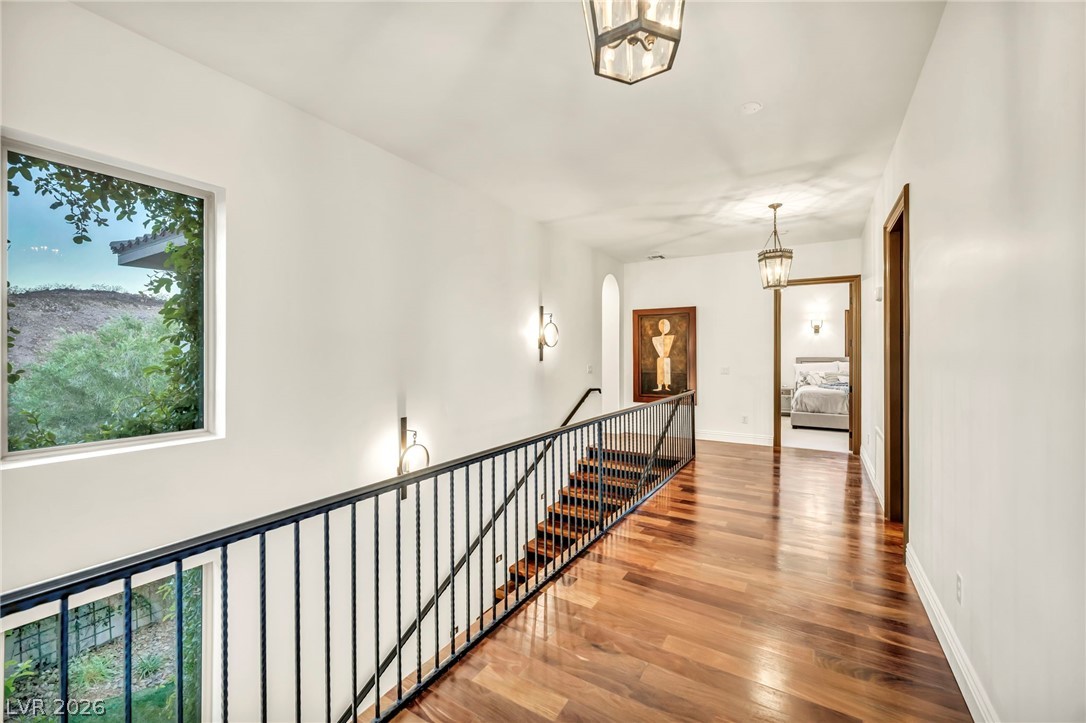 1158 Christian Road Henderson, NV 89002 - Photo 35 of 71 This interior hallway features rich hardwood flooring and a stylish staircase.