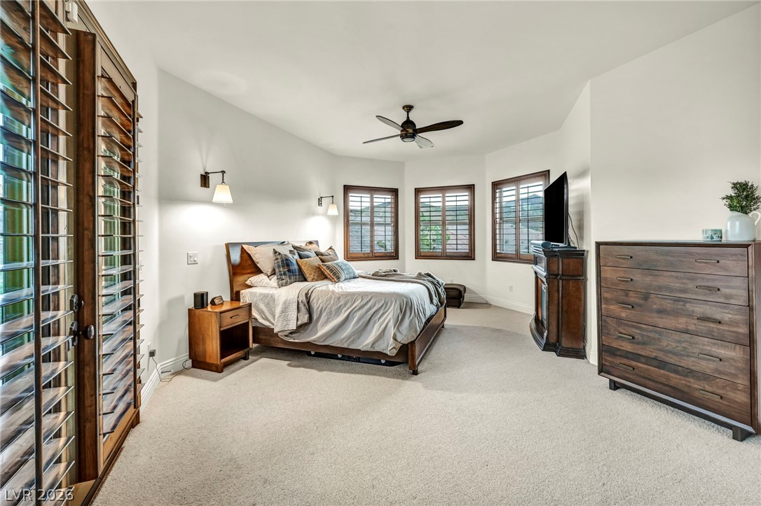 1158 Christian Road Henderson, NV 89002 - Photo 36 of 71 This spacious primary bedroom offers comfort and privacy with ample natural light.