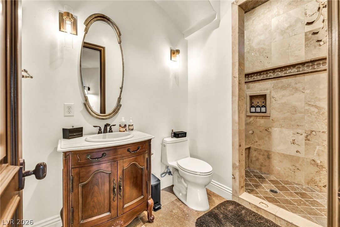 1158 Christian Road Henderson, NV 89002 - Photo 38 of 71 This exquisite bathroom features a custom vanity and an opulent walk-in shower with intricate tile work.