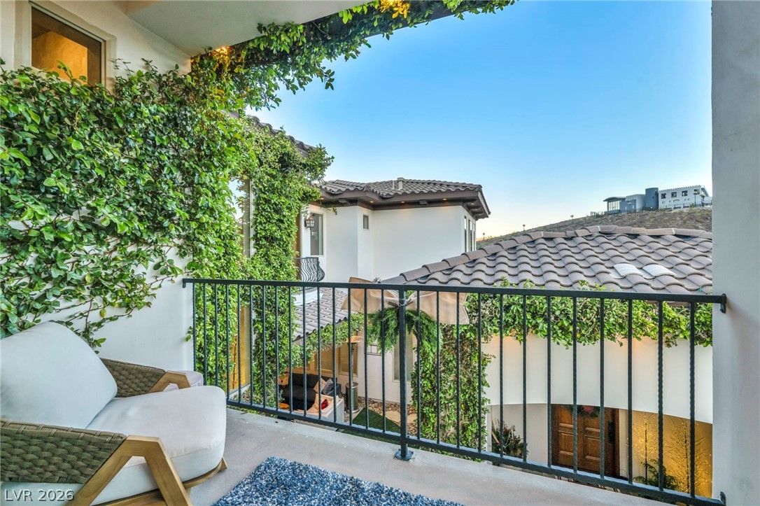 1158 Christian Road Henderson, NV 89002 - Photo 39 of 71 Enjoy the outdoor ambiance from this charming balcony adorned with lush greenery.