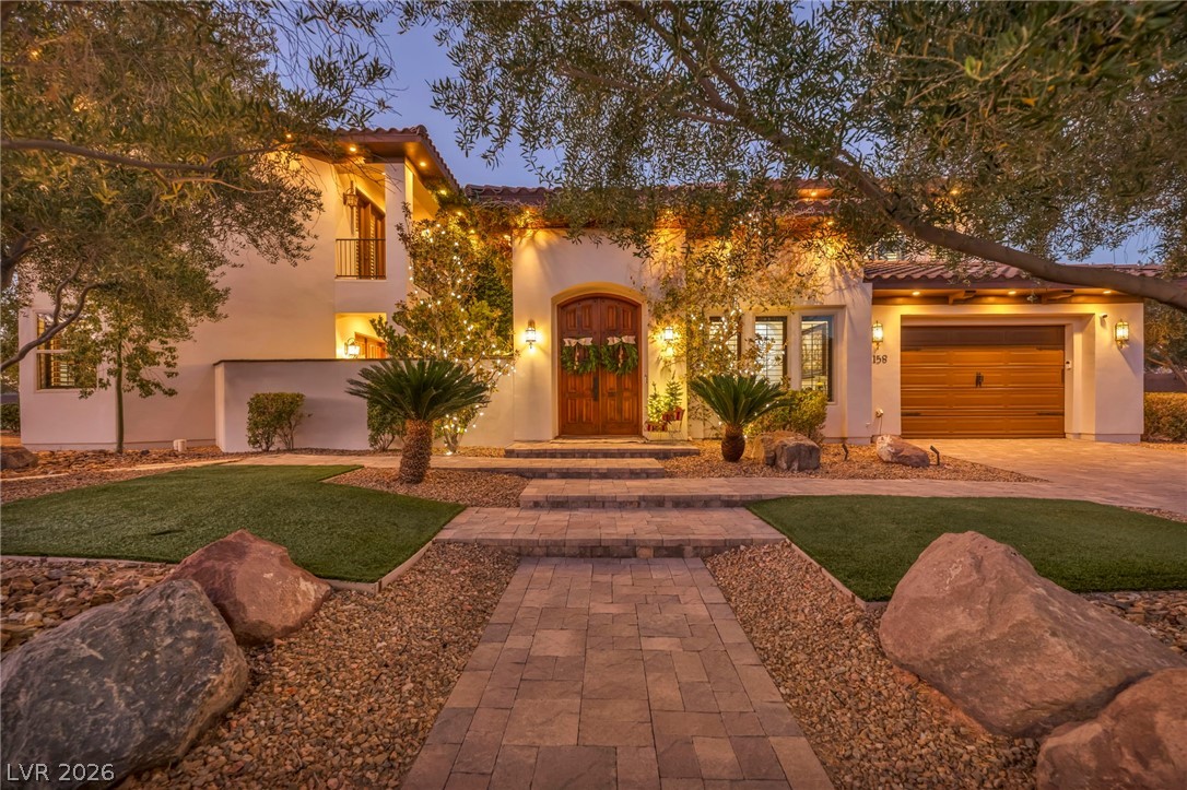 1158 Christian Road Henderson, NV 89002 - Photo 4 of 71 This exquisite home showcases a beautifully landscaped exterior, offering a grand welcome to all who arrive.