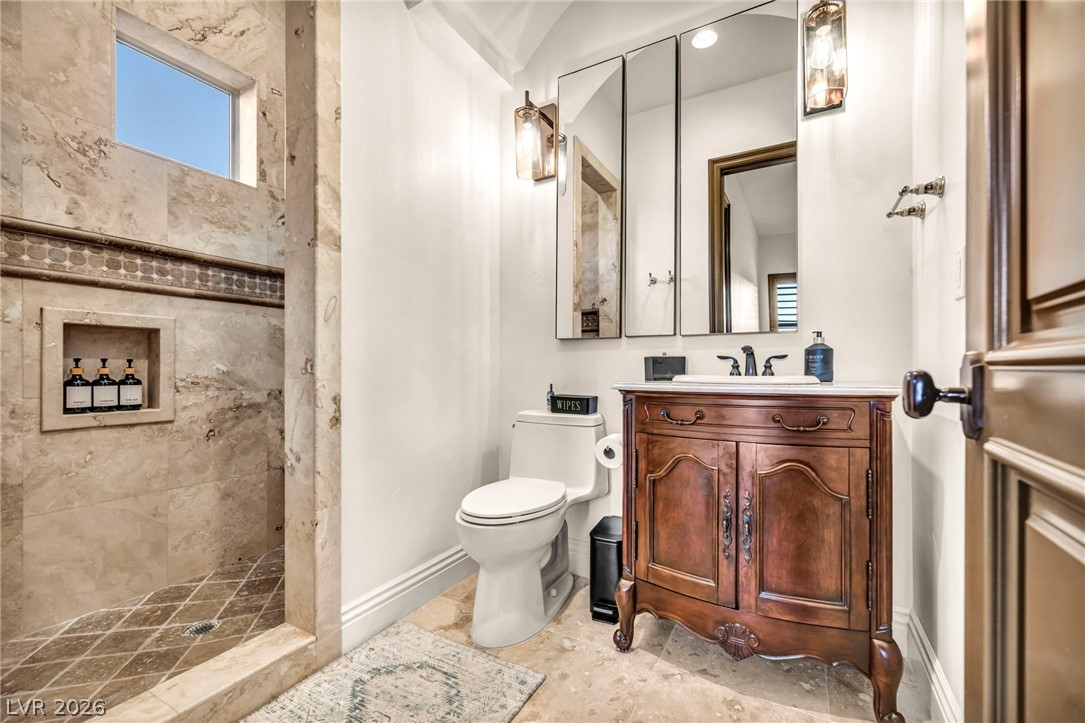 1158 Christian Road Henderson, NV 89002 - Photo 41 of 71 This bathroom features a sophisticated vanity and a tiled shower with a convenient niche.