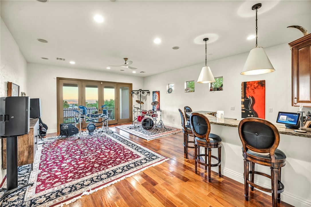 1158 Christian Road Henderson, NV 89002 - Photo 45 of 71 This vibrant entertainment space features rich hardwood flooring and a functional bar.