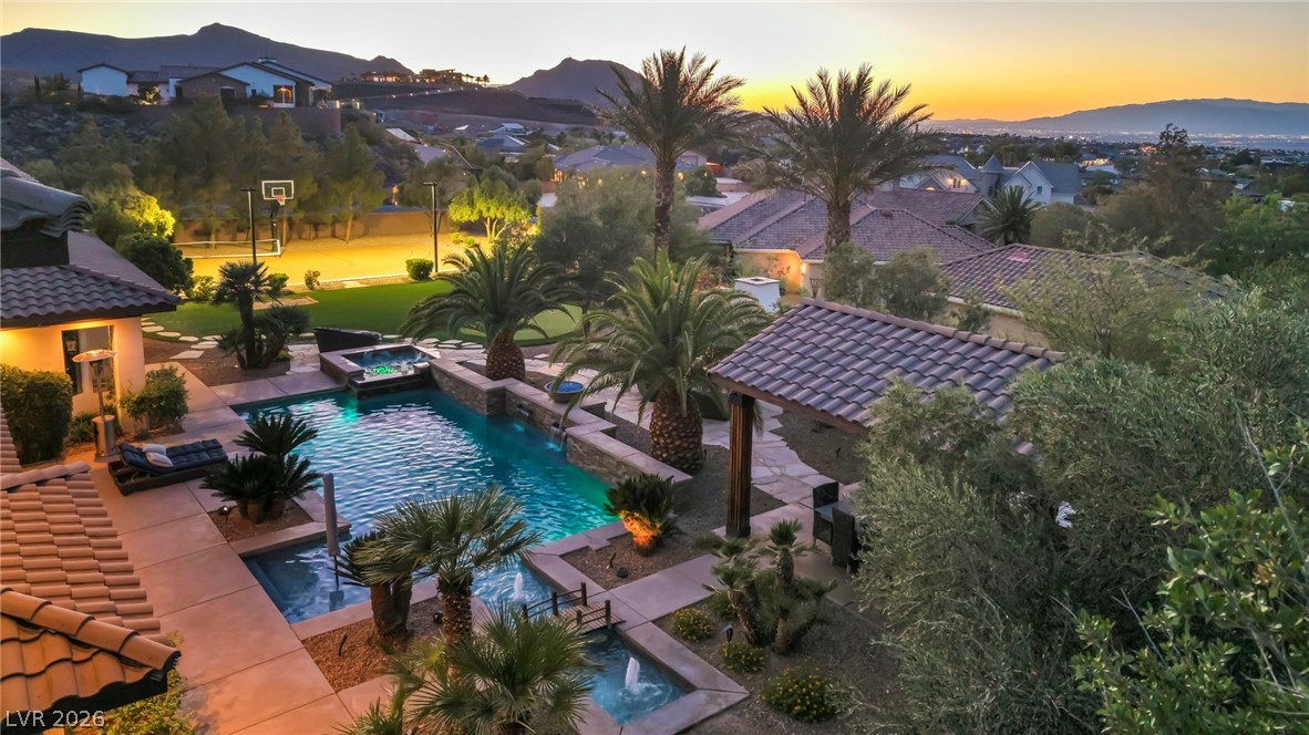 1158 Christian Road Henderson, NV 89002 - Photo 55 of 71 This alluring outdoor oasis offers a refreshing pool and captivating mountain views at sunset.