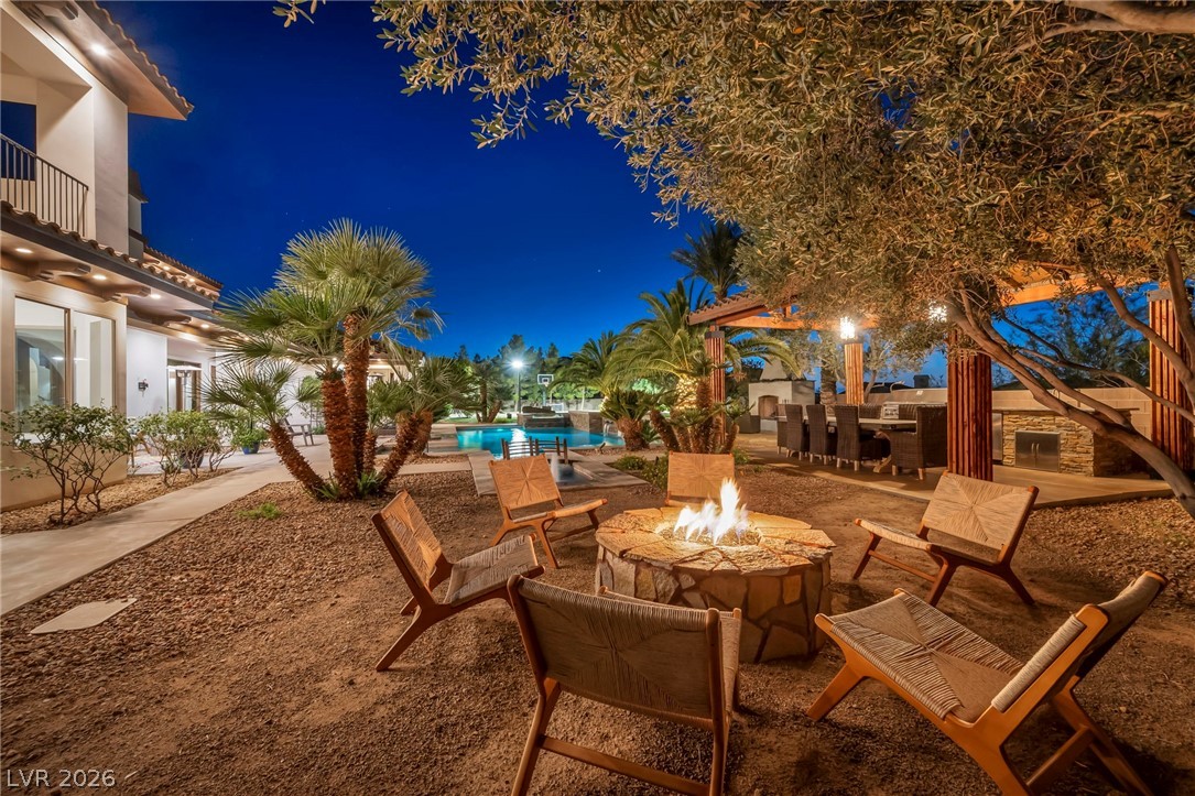1158 Christian Road Henderson, NV 89002 - Photo 56 of 71 This private yard with a fire pit and outdoor kitchen creates an ideal entertaining space.
