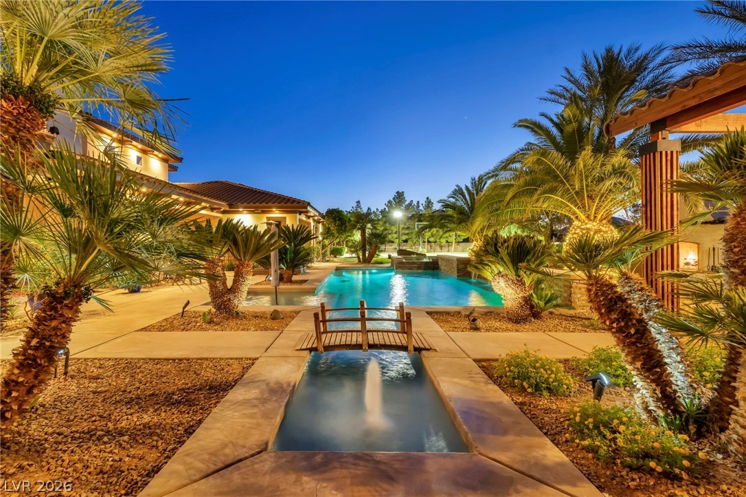 1158 Christian Road Henderson, NV 89002 - Photo 57 of 71 This exquisite outdoor area features a tranquil pool, lush landscaping, and captivating lighting.