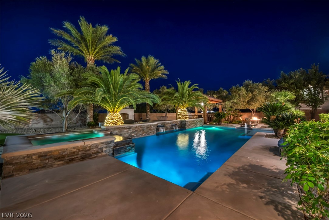 1158 Christian Road Henderson, NV 89002 - Photo 62 of 71 This outdoor oasis offers a serene escape with sparkling pool and lush landscaping.