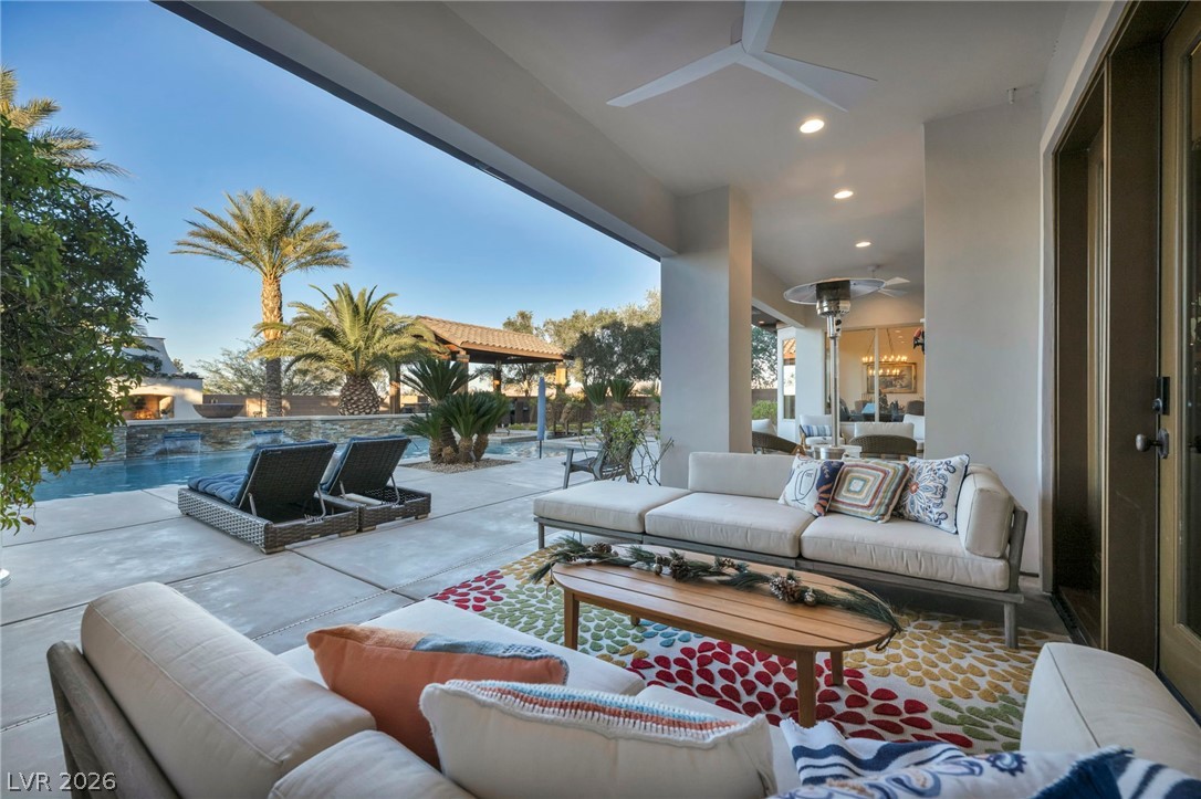 1158 Christian Road Henderson, NV 89002 - Photo 64 of 71 Relax poolside in this serene outdoor living area, perfect for tranquil evenings.