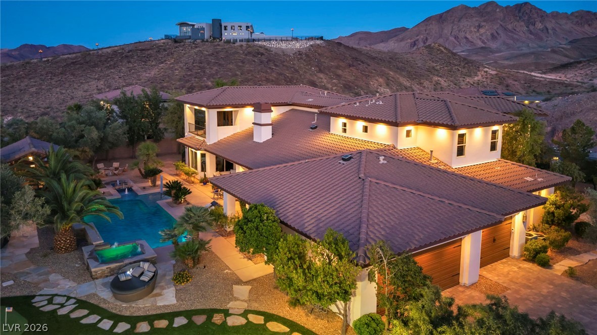 1158 Christian Road Henderson, NV 89002 - Photo 69 of 71 This spacious estate features a beautiful swimming pool and hot tub, with mountain views in the background.