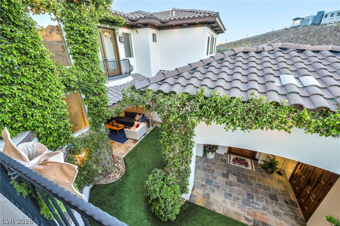 1158 Christian Road Henderson, NV 89002 - Photo 8 of 71 This exquisite home showcases lush greenery adorning its exterior, creating a serene and private ambiance.