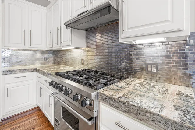 a white stove top oven sitting inside of a kitchen
