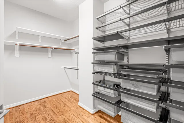 a view of walk in closet with empty racks