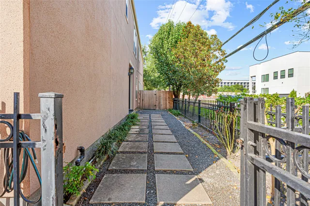 a view of a pathway of a house with a fountain in front of it