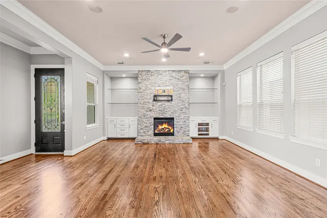 a view of an empty room with a fireplace and a window