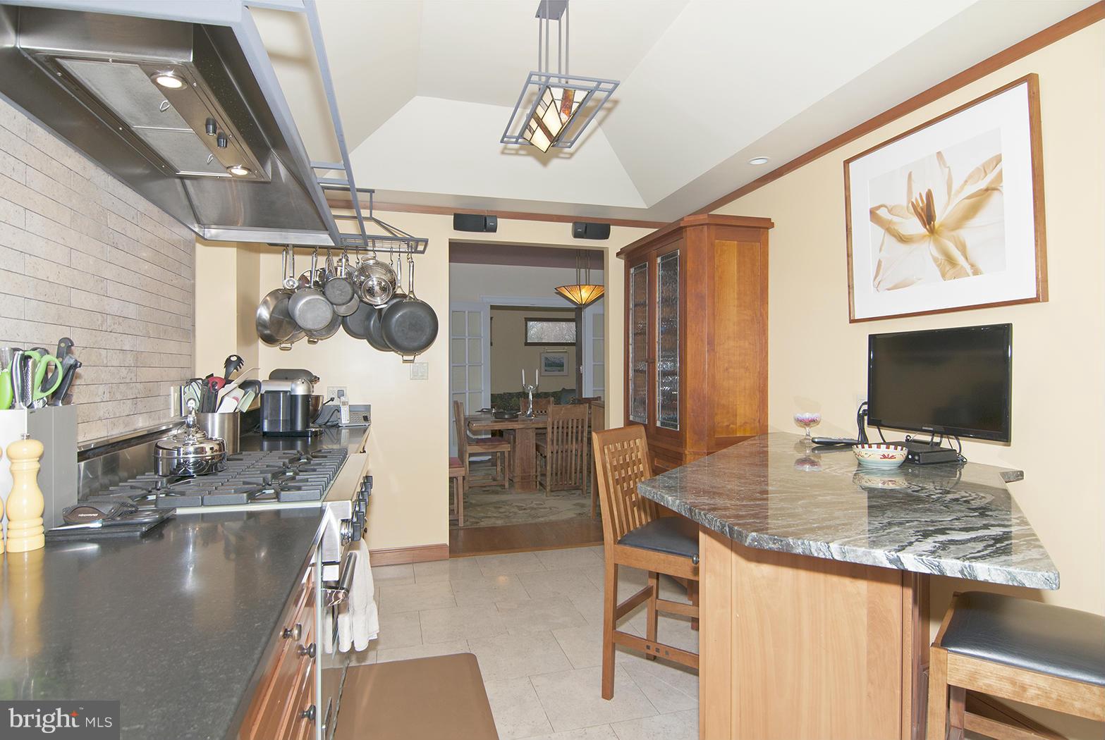4000 Harrison Street Northwest Washington, DC 20015 - Photo 11 of 23 a view of a kitchen with kitchen island granite countertop a sink stainless steel appliances cabinets and furniture