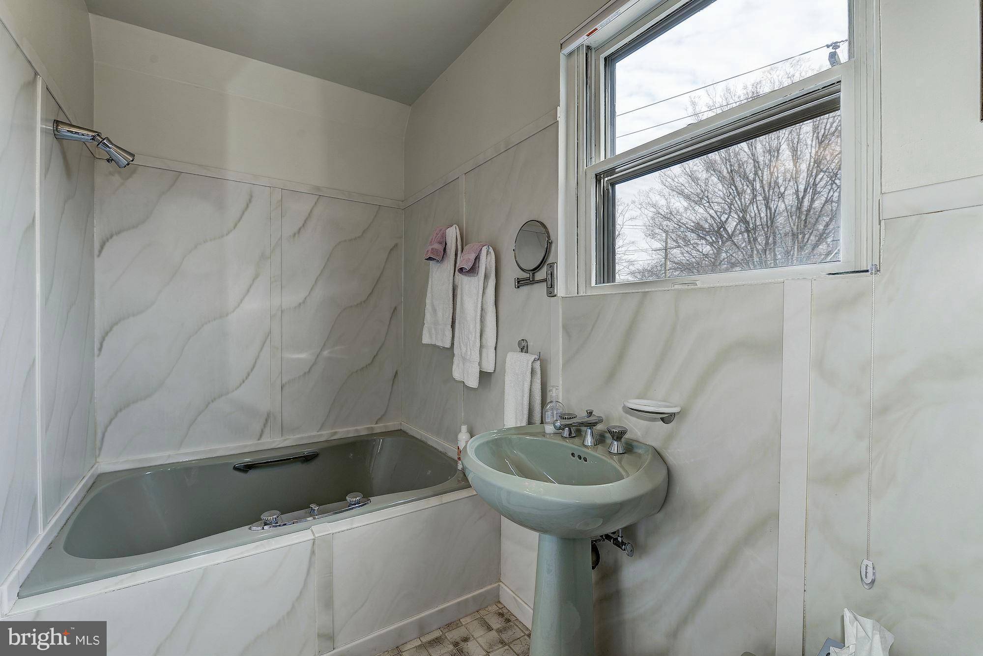 4000 Harrison Street Northwest Washington, DC 20015 - Photo 13 of 23 a bathroom with a sink a window and a shower