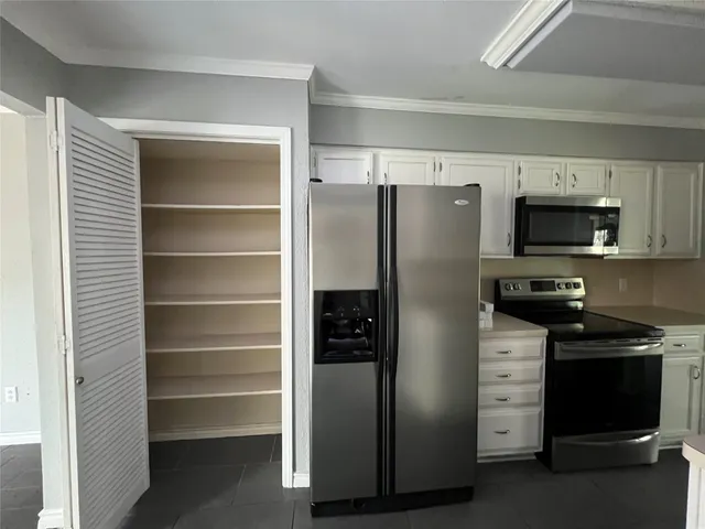 a kitchen with a refrigerator stove and microwave