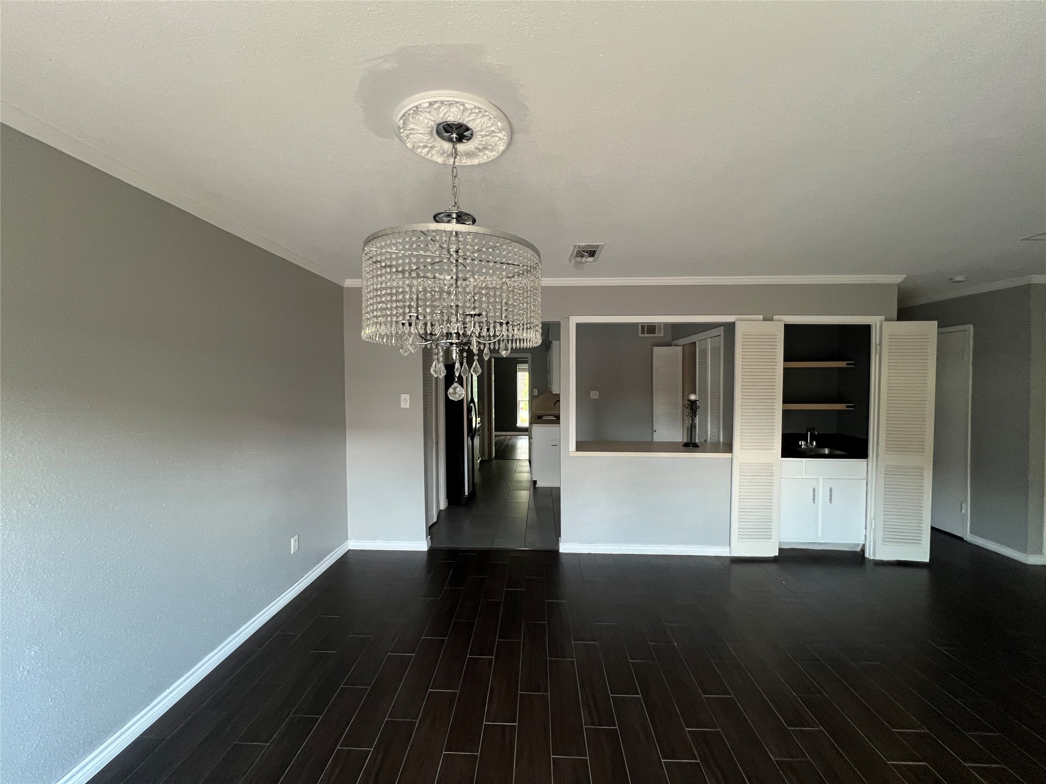 5801 Lumberdale Road, Unit 165 Houston, TX 77092 - Photo 22 of 32 a view of a hallway with wooden floor and chandelier