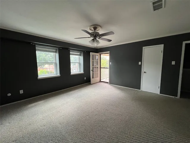 a view of a livingroom with a ceiling fan and window