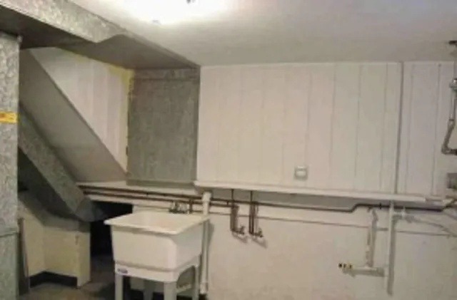 a close view of a sink and a refrigerator in kitchen