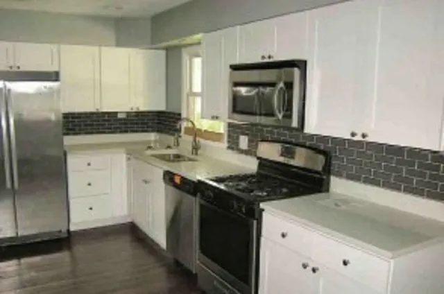 a kitchen with a sink stove and refrigerator