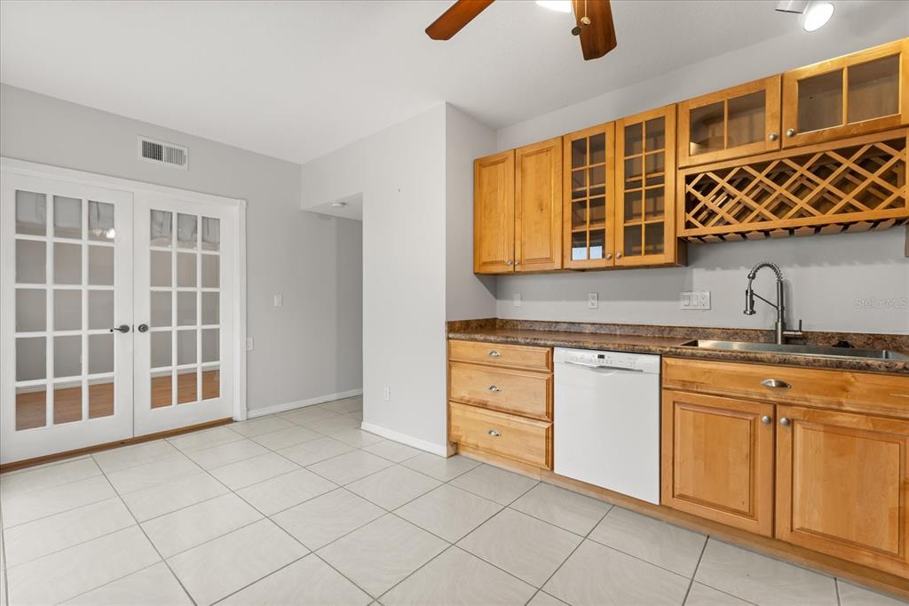 13607 Springtide Court Orlando, FL 32826 - Photo 11 of 32 a kitchen with stainless steel appliances granite countertop a sink and cabinets