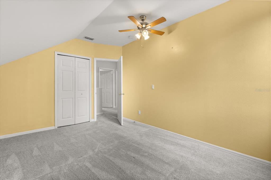 13607 Springtide Court Orlando, FL 32826 - Photo 18 of 32 an empty room with a ceiling fan and a window