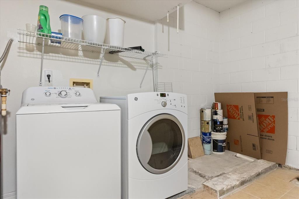 13607 Springtide Court Orlando, FL 32826 - Photo 19 of 32 a utility room with dryer and washer