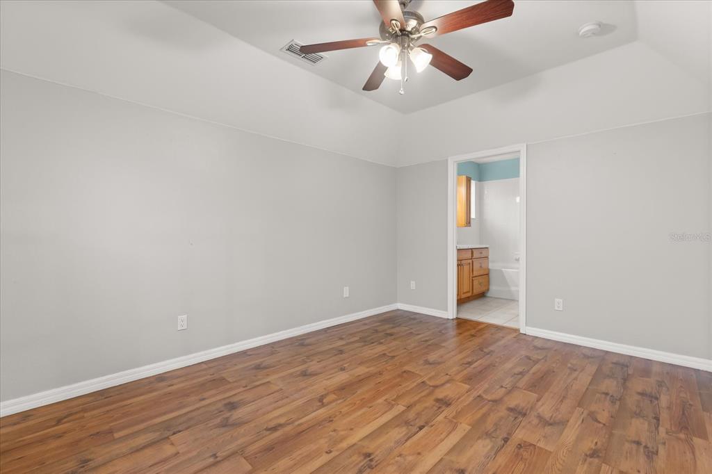 13607 Springtide Court Orlando, FL 32826 - Photo 21 of 32 wooden floor in an empty room