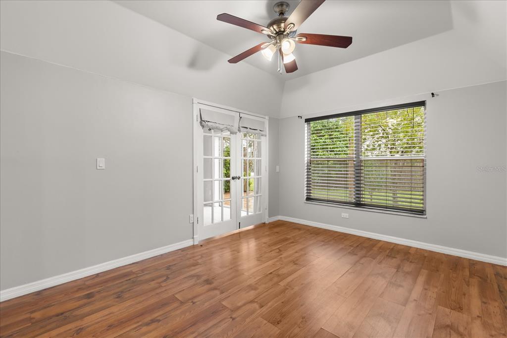 13607 Springtide Court Orlando, FL 32826 - Photo 22 of 32 a view of an empty room with a window and wooden floor