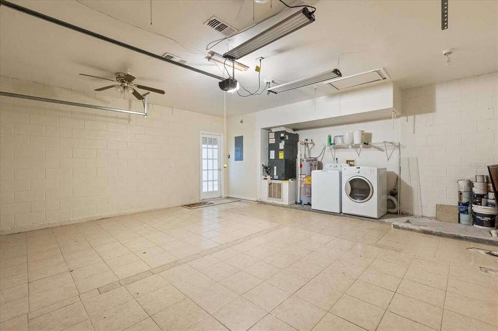 13607 Springtide Court Orlando, FL 32826 - Photo 24 of 32 a view of a storage & utility room with a garage