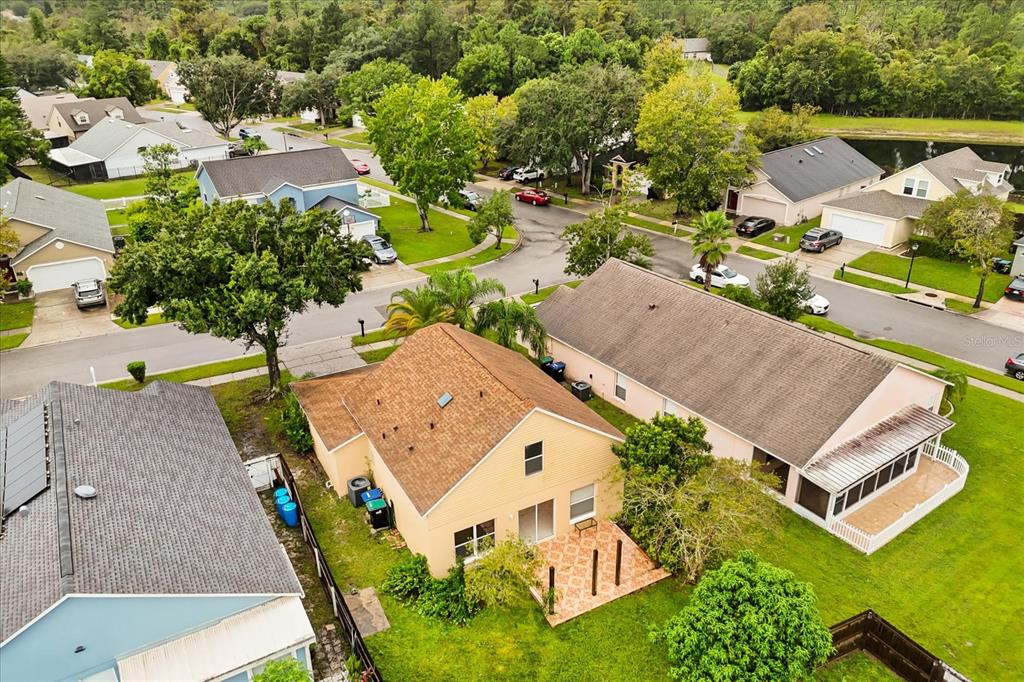 13607 Springtide Court Orlando, FL 32826 - Photo 26 of 32 an aerial view of a house with a garden and lake view