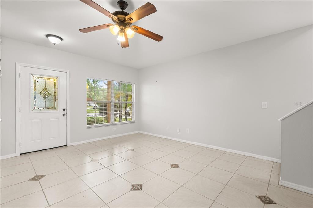 13607 Springtide Court Orlando, FL 32826 - Photo 5 of 32 a view of an empty room with a window