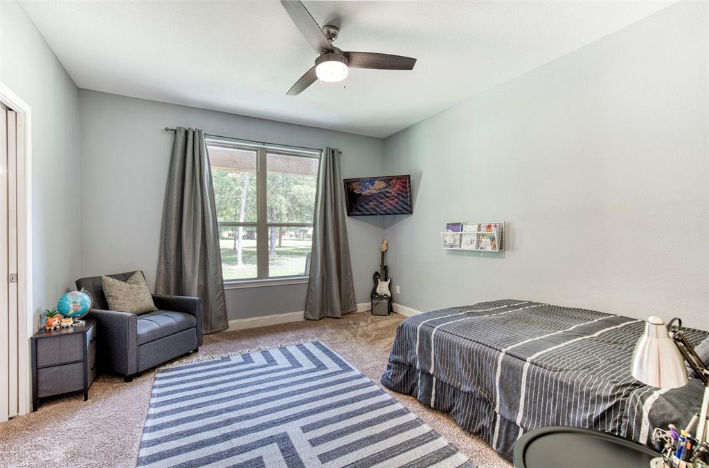 2121 Canyon Lake Road Wills Point, TX 75169 - Photo 14 of 40 a bedroom with a bed and a windows