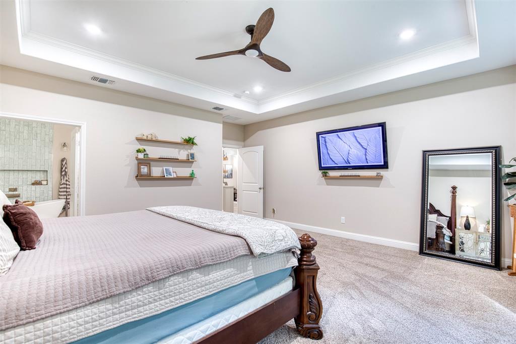 2121 Canyon Lake Road Wills Point, TX 75169 - Photo 19 of 40 a bedroom with a bed and a chandelier