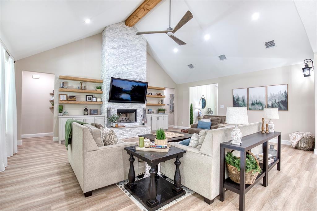 2121 Canyon Lake Road Wills Point, TX 75169 - Photo 2 of 40 a living room with fireplace furniture and a flat screen tv
