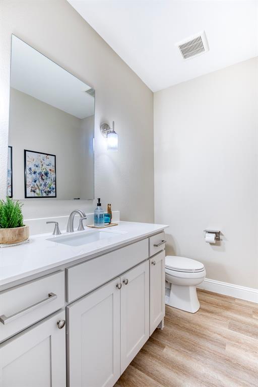 2121 Canyon Lake Road Wills Point, TX 75169 - Photo 27 of 40 a bathroom with a toilet a sink and a mirror